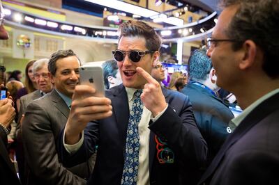 Matthew Kobach, manager of digital and social media at the New York Stock Exchange (NYSE), center, takes a selfie photograph wearing a pair of Snapchat Spectacles by Snap Inc. on the floor of the New York Stock Exchange (NYSE) during the company's initial public offering (IPO) in New York, U.S., on Thursday, March 2, 2017. Snap Inc., maker of the disappearing photo app that relies upon the fickle favor of millennials, jumped in its trading debut after pricing its initial public offering above the marketed range. Photographer: Michael Nagle/Bloomberg