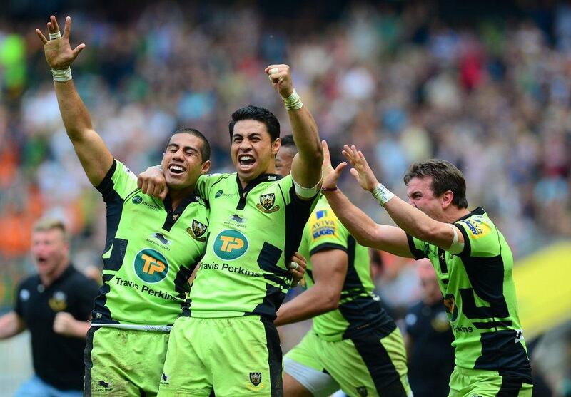 Ken Pisi, left, and George Pisi, right, of Northampton Saints celebrate following their victory in the Aviva Premiership final on Saturday over Saracens. Jamie McDonald / Getty Images / May 31, 2014