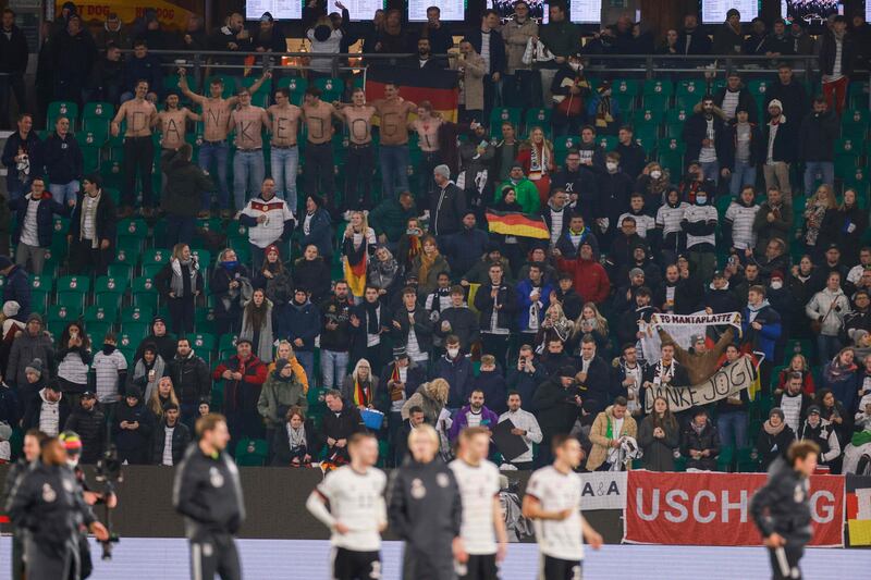 Germany fans take their shirts off to show a thank you message for former Germany head coach Joachim Low as a tribute to the World Cup winning coach. AFP