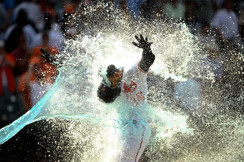 Baltimore Orioles' Anthony Santander is doused as he celebrates heading home in the ninth innings of a baseball game against the New York Yankees in Baltimore. The Orioles won 9-6. AP