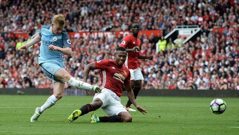 Manchester City's Belgian midfielder Kevin De Bruyne (L) hits the post with this attempt during the English Premier League football match between Manchester United and Manchester City at Old Trafford in Manchester, north west England, on September 10, 2016. (Photo by Oli SCARFF / AFP) / RESTRICTED TO EDITORIAL USE. No use with unauthorized audio, video, data, fixture lists, club/league logos or 'live' services. Online in-match use limited to 75 images, no video emulation. No use in betting, games or single club/league/player publications. / 