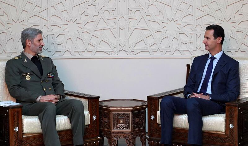 A handout picture released by the Syrian Arab News Agency (SANA) on August 26, 2018, shows Iranian Defence Minister Amir Hatami (L) meeting with Syrian President Bashar al-Assad (R)in the capital Damascus. - Iran's top defence official arrived in Syria today on a two-day visit. (Photo by Handout / SANA / AFP) / == RESTRICTED TO EDITORIAL USE - MANDATORY CREDIT "AFP PHOTO / HO / SANA" - NO MARKETING NO ADVERTISING CAMPAIGNS - DISTRIBUTED AS A SERVICE TO CLIENTS ==