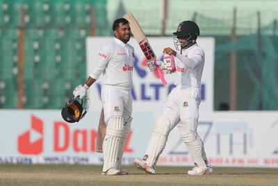 Bangladesh's Zakir Hasan, left, celebrates scoring a century on Saturday. AP