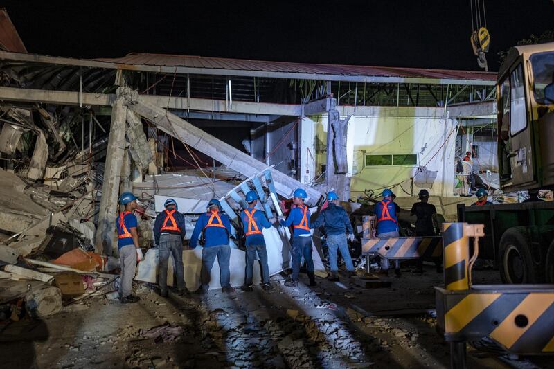 Rescuers search for survivors trapped in the debris. Getty