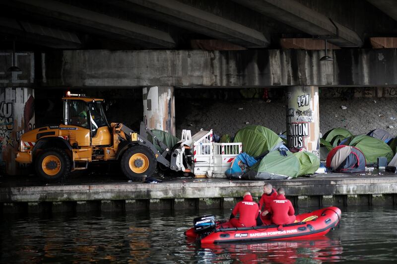 A makeshift camp is cleared away as French police evacuate hundreds of migrants living in tents along a canal in Paris, France. Benoit Tessier / Reuters