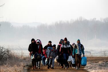 Migrants walk along the Evros river to reach Greece, near the Turkish border city of Edirne. Reuters