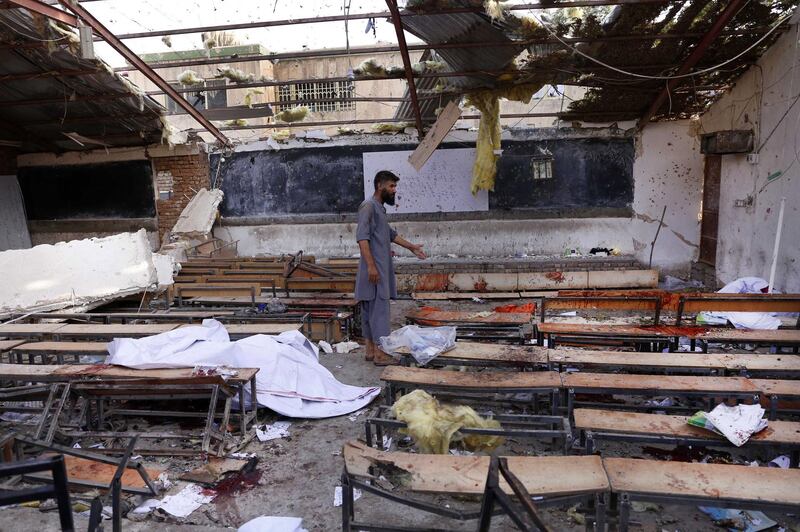 epa06951173 Afghan man inspects the scene of a suicide bomb attack in Kabul, Afghanistan, 15 August 2018. At least 25 people were killed when a suicide bomber attacked an educational institute frequented by the Shi'ite Muslims in Kabul.  EPA/HEDAYATULLAH AMID