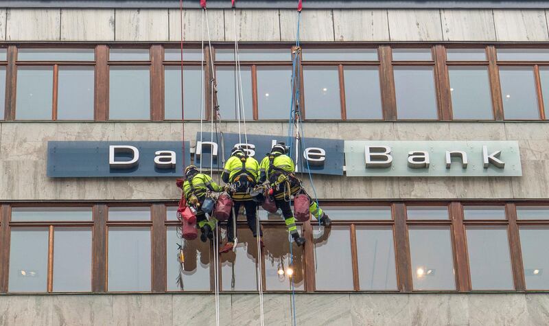 Workers are seen next to a "Danske Banks" sign in central Stockholm, Sweden April 7, 2016. The Danish bank "The Danske bank" is in a crisis due to alleged money laundering. Picture taken April 7, 2016. ATTENTION EDITORS - THIS IMAGE WAS PROVIDED BY A THIRD PARTY. SWEDEN OUT. NO COMMERCIAL OR EDITORIAL SALES IN SWEDEN.