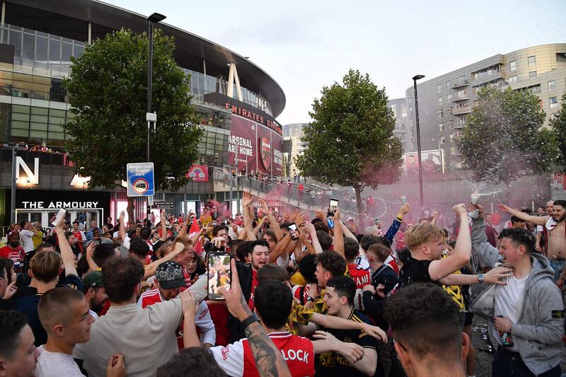 Arsenal fans celebrate outside the Emirates stadium. AFP