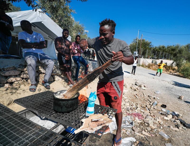 Marmaro, Mytilene, Greece, September 12, 2018.  The Moria "Open" refugee camp.    Ugandan and Cameroon refugees cook a meal.
Victor Besa/The National
Section:  WO
Reporter:  Anna Zacharias