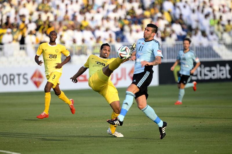 Baniyas striker Denis Stracqualursi, No 11, challenges an Al Wasl defender for the ball during their President's Cup round of 16 match at Baniyas Stadium in Abu Dhabi, on May 15, 2015. Lee Hoagland/The National