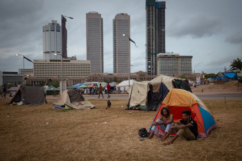 Protesters sit outside tents at the site of a demonstration in Colombo, Sri Lanka. Many Tamils have fled the country for India. Getty