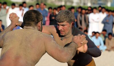 (FILES) In this file photo taken on March 16, 2018 Pakistani immigrant workers in the United Arab Emirates take part in a Kushti competition in Dubai. 
Kushti is popular in India, Pakistan and Bangladesh and was developed in the Mughal era by combining native 'malla-yuddha' wrestling with Persian 'pahlavani'. Every Friday evening in Dubai's bustling Deira district, a sandy lot is transformed into the ring of champions. It is kushti wrestling night and Kala Pehlwan is ready to fight. / AFP PHOTO / KARIM SAHIB
