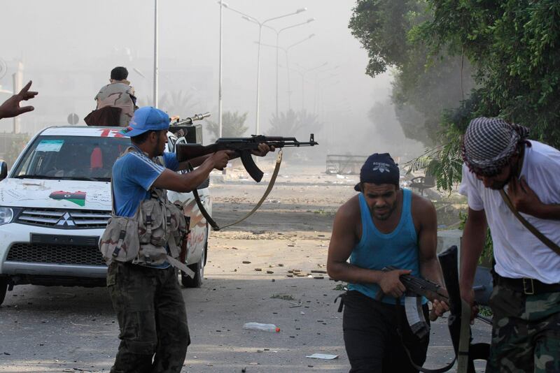 Libyan rebel fighters fire their weapons during a fight for the final push to flush out Muammar Gaddafi's forces in Abu Salim district in Tripoli August 25, 2011. Gaddafi taunted his Libyan enemies and their Western backers as rebel forces battled pockets of loyalists across Tripoli in an ever more urgent quest to find and silence the fugitive strongman. REUTERS/Anis Mili (LIBYA - Tags: POLITICS CONFLICT) *** Local Caption ***  ANIS36_LIBYA_0825_11.JPG