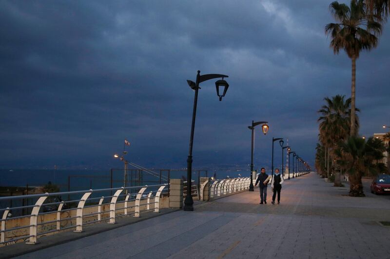 A couple walks at Beirut's seaside corniche, or waterfront promenade, along the Mediterranean Sea, which is almost empty of residents and tourists in Beirut, Lebanon, Saturday, March 21, 2020. Lebanon has been taking strict measures to limit the spread of the coronavirus closing restaurants and nightclubs as well as schools and universities. For most people, the new coronavirus causes only mild or moderate symptoms. For some it can cause more severe illness. (AP Photo/Bilal Hussein)