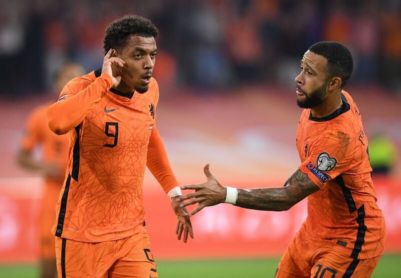 Netherlands forward Donyell Malen, left, celebrates with Memphis Depay after scoring a goal during the World Cup Qatar 2022 qualifying Group G match against Turkey at the Johan Cruijff Arena in Amsterdam. AFP