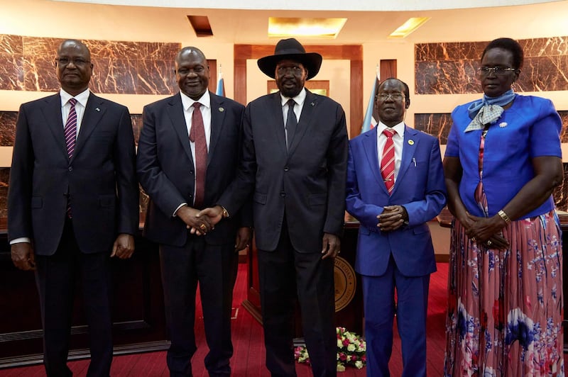 South Sudanes President Salva Kiir shakes hands with First Vice President Dr Riek Machar as Third Vice President Taban Deng Gai, Second Vice President James Wani Igga and Fourth Vice President Rebecca Garang attend their swearing-in ceremony at the State House in Juba.  AFP