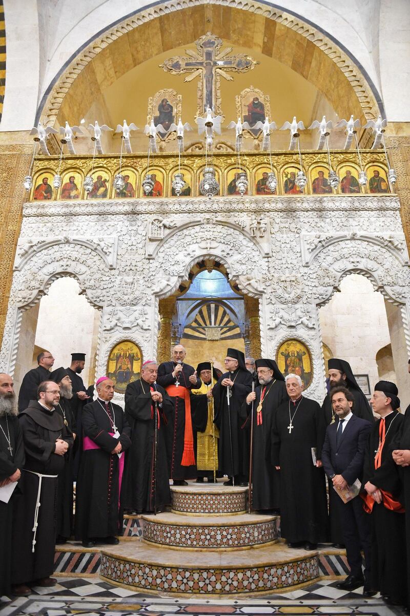 Patriarch of the Melkite Greek Catholic Church Youssef Al Absi, centre, leads prayers  during the re-opening of the Greek Catholic Church of Our Lady, in Aleppo.
