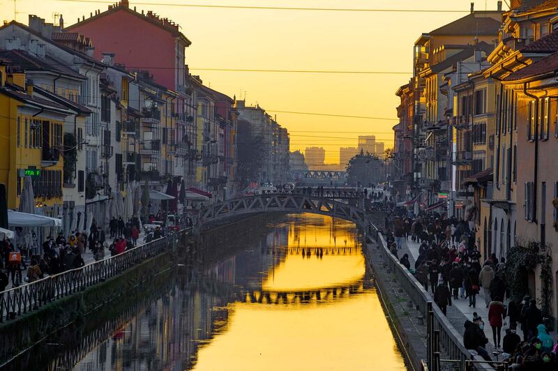 Crowds stroll along a canal in the Navigli district of Milan, Italy. EPA