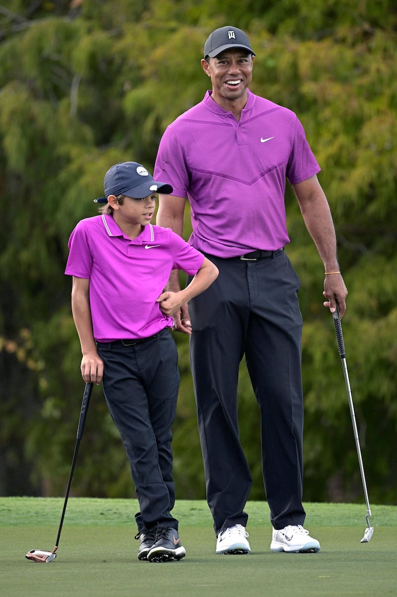 Tiger Woods, right, and his son Charlie have a laugh. AP