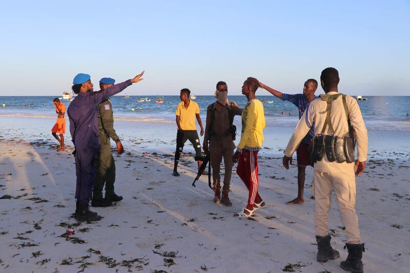 Somali police officers disperse people from the Lido beach in Mogadishu, Somalia enforcing a ban on public gathering to curb the spread of Covid-19 coronavirus. AFP