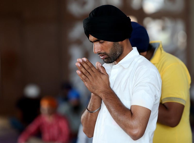 Dubai, United Arab Emirates-September,23,2015: Devotees pray at the Sikh Gurudwara, Guru Nanak Darbar in Dubai.  ( Satish Kumar / The National ) For News / Story by Ramola Talwar *** Local Caption ***  SK-DubaiGurudwara-23092015-05.jpg