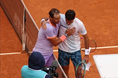 Rafael Nadal, left, embraces Pedro Cachin at the net following their match at the Madrid Open. Getty