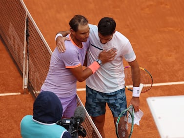 Rafael Nadal, left, embraces Pedro Cachin at the net following their match at the Madrid Open. Getty