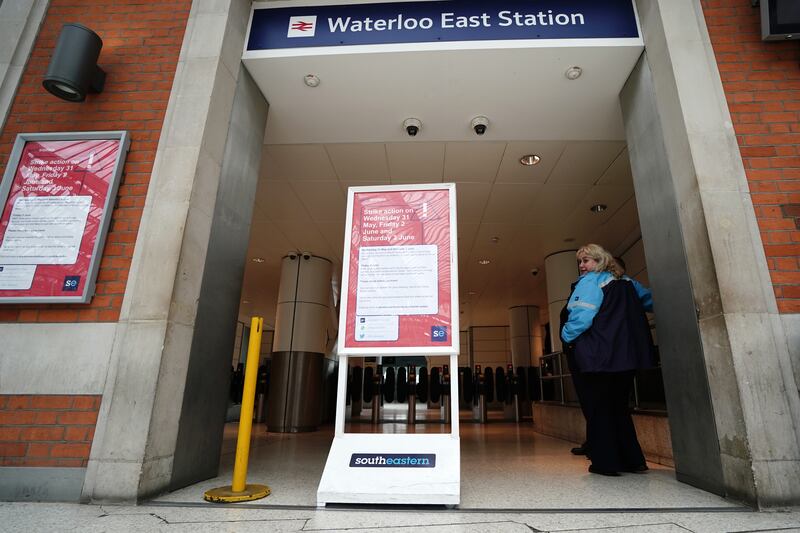 A sign warns passengers of strikes at Waterloo Station in central London. PA