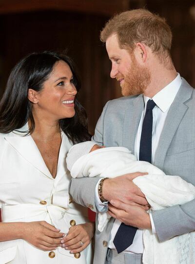 FILE - In this Wednesday, May 8, 2019 file photo, Britain's Prince Harry and Meghan, Duchess of Sussex smile during a photocall with their newborn son, in St George's Hall at Windsor Castle, Windsor, south England. Sunday, May 19, 2019 marks the first wedding anniversary of the besotted couple. (Dominic Lipinski/Pool via AP, File)