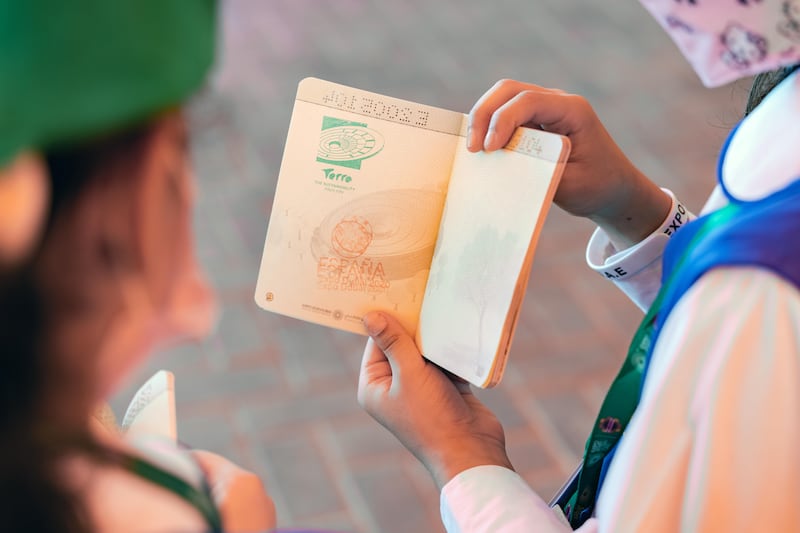 A pupil shows off her stamp collection in her Expo 2020 passport.