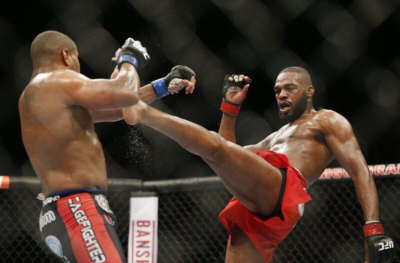 Jon Jones kicks Daniel Cormier during their fight at UFC 182 on Saturday in Las Vegas. John Locher / AP