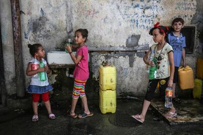 Palestinian children fill jerricans with drinking water from public taps at a refugee camp in Rafah in the southern Gaza Strip on July 30, 2019. An internal ethics report has alleged mismanagement and abuses of authority at the highest levels of the UN agency for Palestinian refugees even as the organisation faced an unprecedented crisis after US funding cuts.
Lacking natural resources, the Gaza Strip suffers from a chronic shortage of water, electricity and petrol. More than two-thirds of the population depends on humanitarian aid. / AFP / SAID KHATIB

