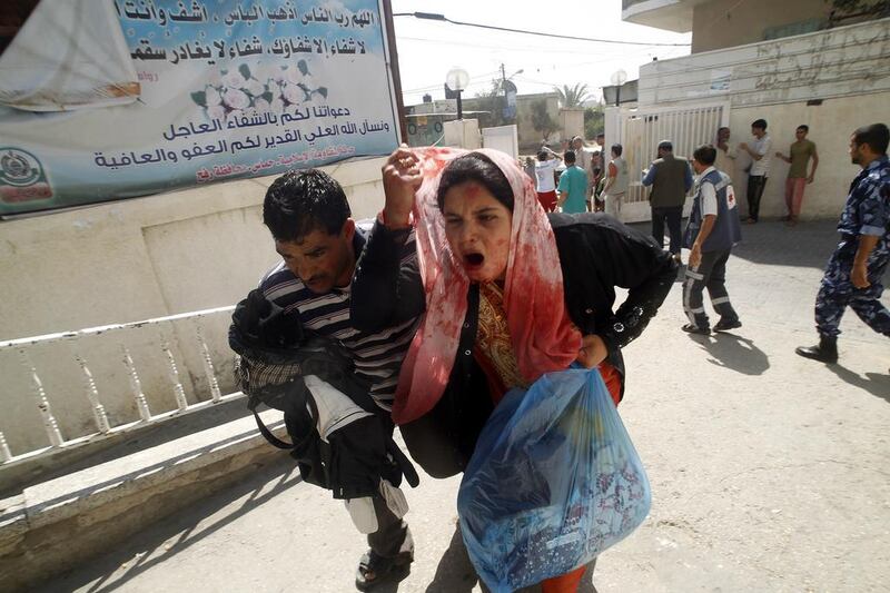 A wounded Palestinian woman arrives at Al Najar hospital in southern Gaza yesterday, after the US-brokered ceasefire was shattered.  Said Khatib / AFP

