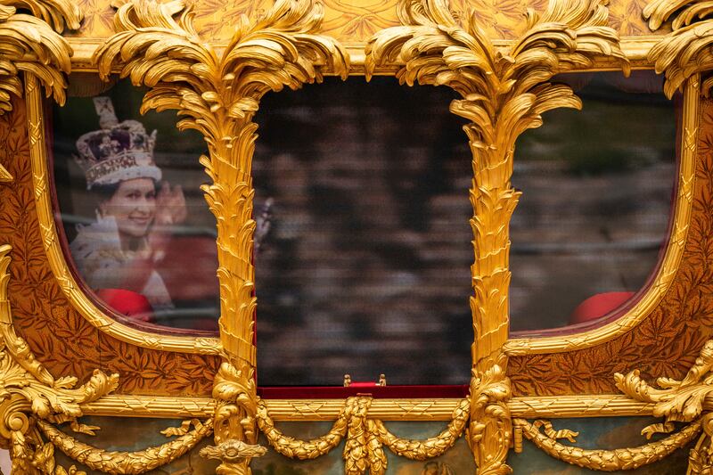 A hologram of Queen Elizabeth on the windows of the Gold State Coach during the Platinum Jubilee Pageant in June 2022. AP