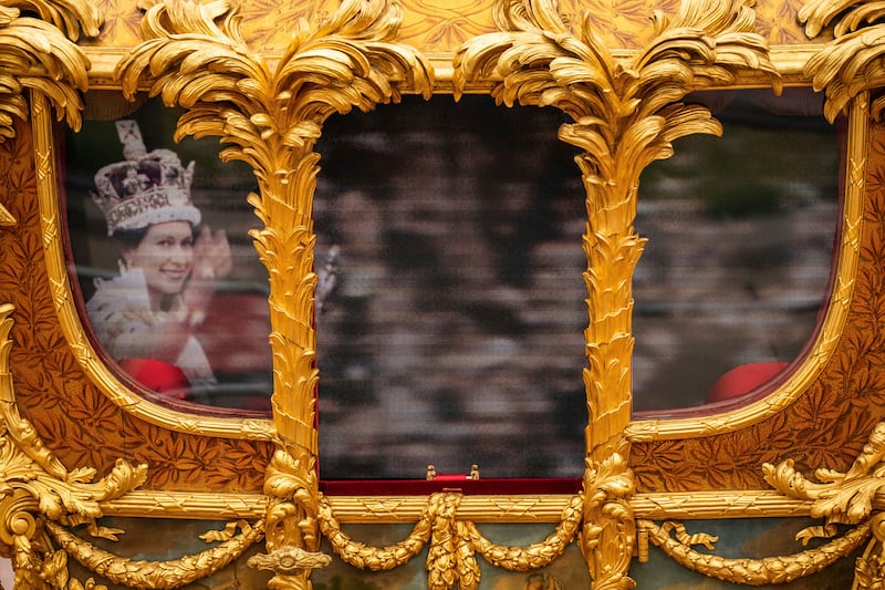 A hologram of Queen Elizabeth on the windows of the Gold State Coach during the Platinum Jubilee Pageant in June 2022. AP