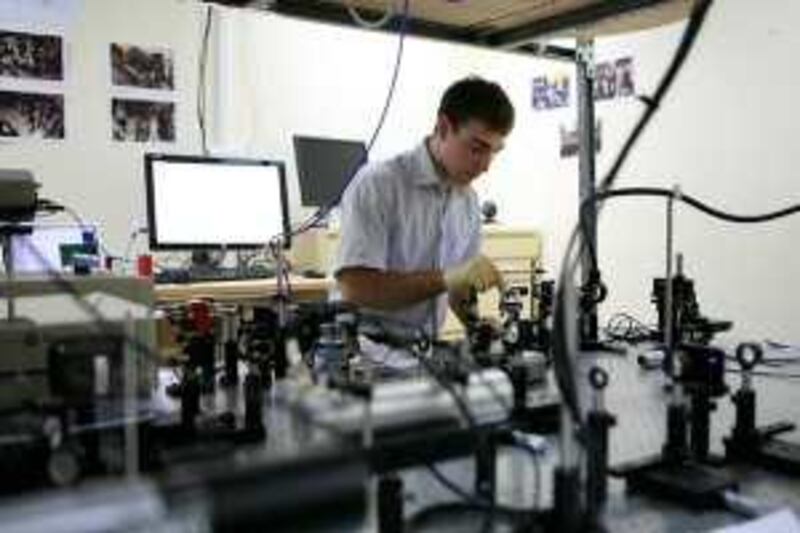 Abu Dhabi - March 26, 2009: Aaron Schmidt, 29, a researcher, works on energy material characterization in the lens lab at the Masdar Institute and Technology. ( Philip Cheung / The National )   *** Local Caption ***  PC0003-Masdar.jpg