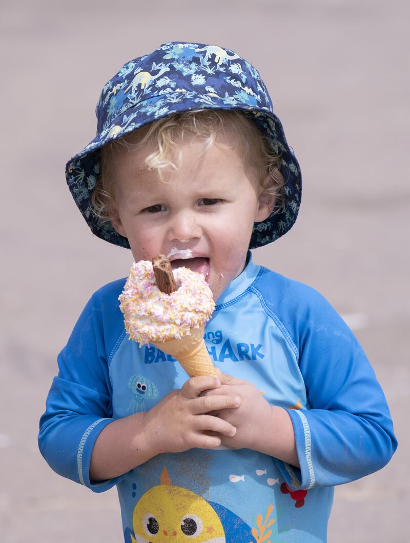 A cooling ice cream for a young beach-goer in Bridlington, Yorkshire. PA