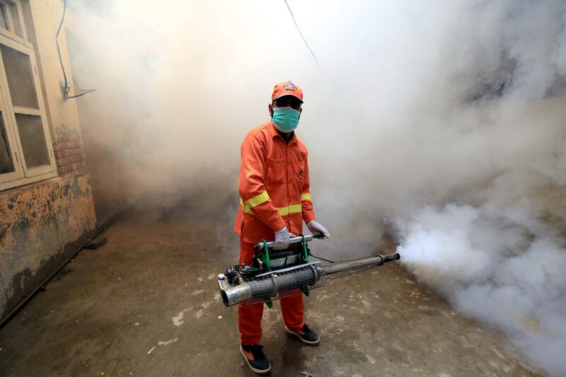 A Pakistani worker sprays an area to prevent dengue fever in Peshawar, Pakistan. Colder countries such as Greece are starting to see a spike in mosquitos and disease. EPA