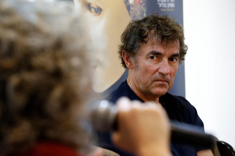 French actor, film director, and screenwriter Albert Dupontel, whose film "Au Revoir Là Haut" opens the 15th French Film Festival in Israel, listens to journalists at the Institut Francais in Tel Aviv on March 14, 2018. - The film was awarded 5 Cesar awards, including "Best Director", at 43rd edition of the Cesar Awards ceremony in Paris on March 2. (Photo by JACK GUEZ / AFP)