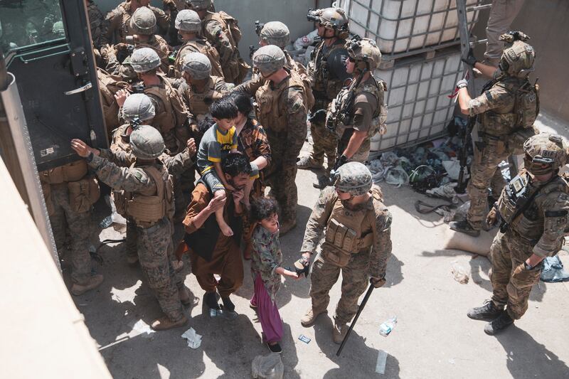 US marines and Norwegian coalition forces provide security during an evacuation at Kabul's airport. Reuters