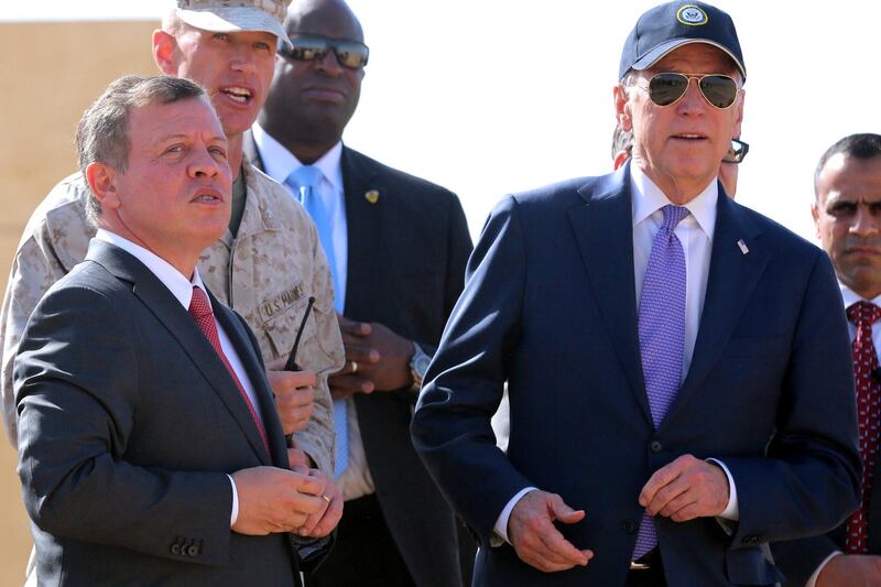 Jordan's King Abdullah II (L) and US vice president Joe Biden (R) attend a military demonstration at a Joint Training Center outside the city of Zarqa, northeast of the capital Amman, on March 10, 2016. - Biden met with King Abdullah during a visit to Jordan, a key ally in the fight against the Islamic State jihadist group, on the latest leg of a Middle East tour. (Photo by KHALIL MAZRAAWI / AFP) / “The erroneous mention[s] appearing in the metadata of this photo by KHALIL MAZRAAWI has been modified in AFP systems in the following manner: [in the city of Zarqa] instead of [outside the city of Zarqa]. Please immediately remove the erroneous mention[s] from all your online services and delete it (them) from your servers. If you have been authorized by AFP to distribute it (them) to third parties, please ensure that the same actions are carried out by them. Failure to promptly comply with these instructions will entail liability on your part for any continued or post notification usage. Therefore we thank you very much for all your attention and prompt action. We are sorry for the inconvenience this notification may cause and remain at your disposal for any further information you may require.”