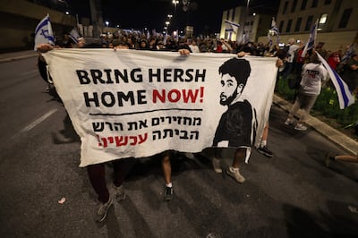 Demonstrators hold a banner during a protest against the Israeli government and to demand a secure release of hostages held by Hamas. AFP