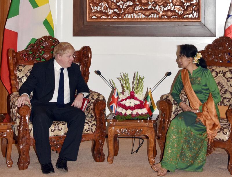 In this image provided by Ministry of Information, Britain's Foreign Secretary Boris Johnson, left, speaks with Myanmar's Foreign Minster Aung San Suu Kyi during their meeting at Foreign Ministry Office in Naypyitaw, Myanmar, Sunday, Feb. 11, 2018. (Ministry of Information via AP)