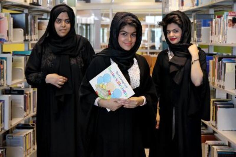 United Arab Emirates - Dubai - March 10, 2011.

NATIONAL: Dubai Women's College business students (left to right) Maitha Khalfan (cq-al), 21, Maryam Jalal (cq-al), 20, and Muna Al Bloushi (cq-al), 18, pose for their portraits inside the school library in Dubai on Wednesday, March 10, 2011. The students will read to younger children in UAE schools as part of a literacy initiative. "At our age, we didn't read," said Jalal through an interpreter. "We want to encourage them to read to be better in the future." Amy Leang