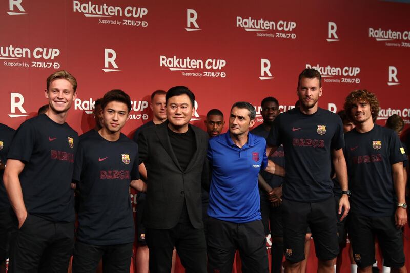 Barcelona's new football players Frenkie de Jong, left,, Hiroki Abe, Norberto Murara Neto and Antoine Griezmann pose with Japanese Rakuten company President and CEO Hiroshi Mikitani. AFP