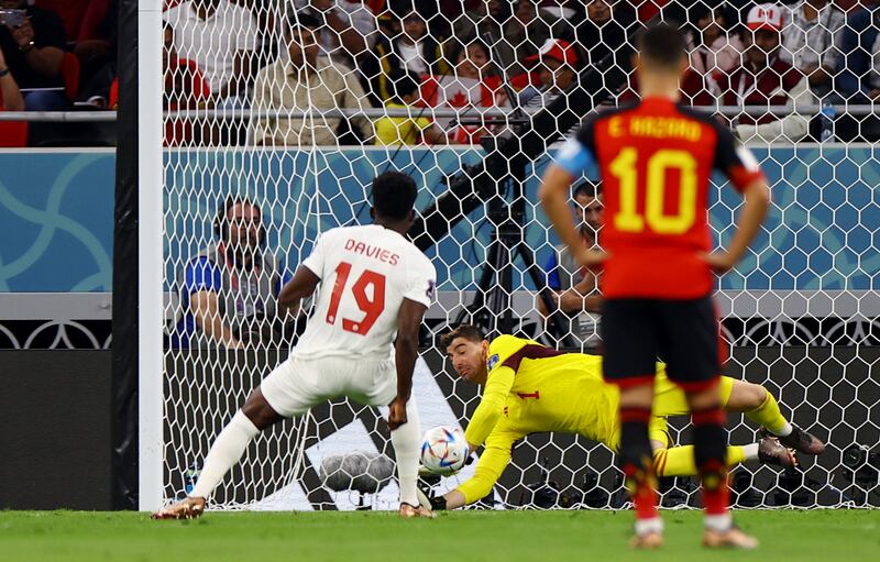 Belgium's Thibaut Courtois saves a penalty missed by Canada's Alphonso Davies. Reuters