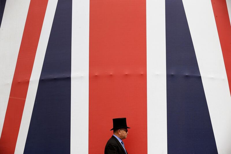 A racegoer walks past a huge British flag during the second day of the Royal Ascot horse race meeting in Ascot, England. Tim Ireland / AP Photo