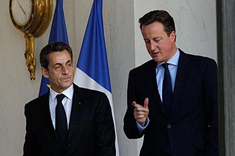 David Cameron, the British premier, right, has widened the diplomatic gulf with the French president, Nicolas Sarkozy, by vetoing a new European Union treaty to tackle the Euro debt crisis.