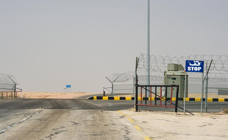 A picture taken on March 12, 2017 shows a road sign reading in Arabic "Stop" near the fence separating Saudi Arabia and Iraq, in the area around Arar city along the Saudi-Iraq border on March 12, 2017. (Photo by FAYEZ NURELDINE / AFP)